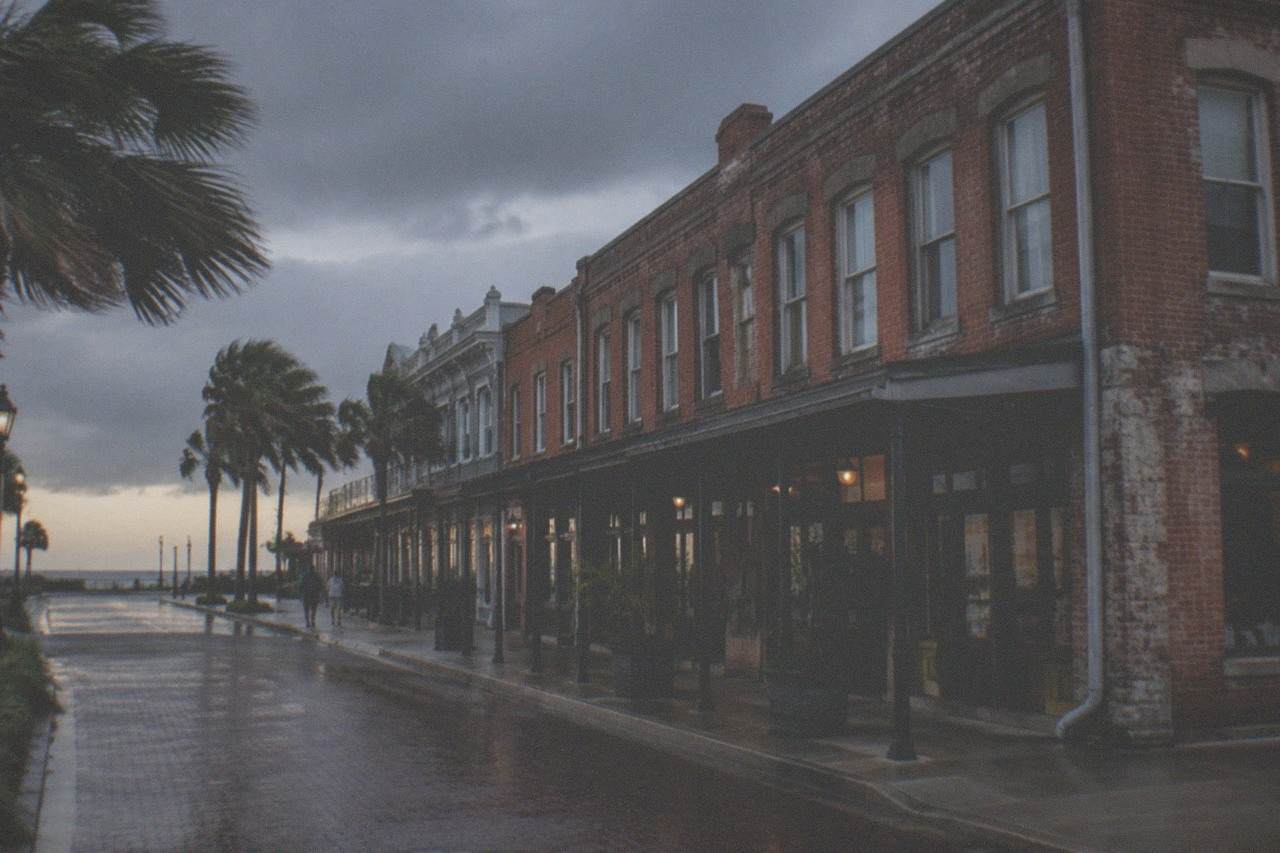 Weathered historic brick buildings along a Galveston street under an evening sky