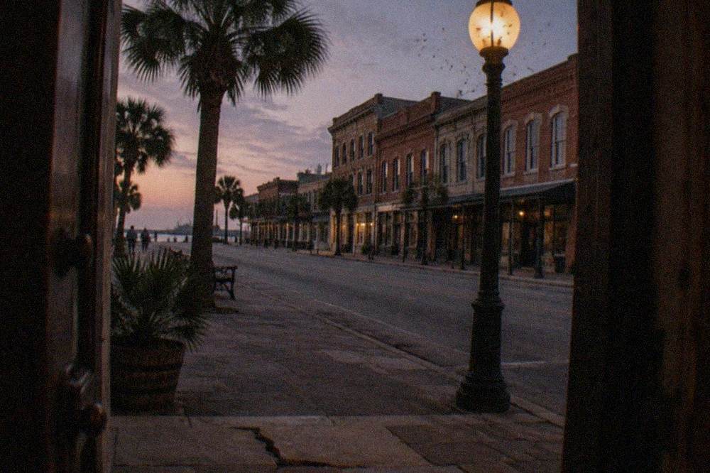 Historic brick buildings on a downtown Galveston street at twilight