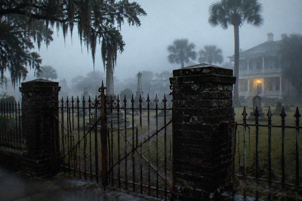Iron cemetery gates and a stone wall surrounding an old graveyard in Galveston